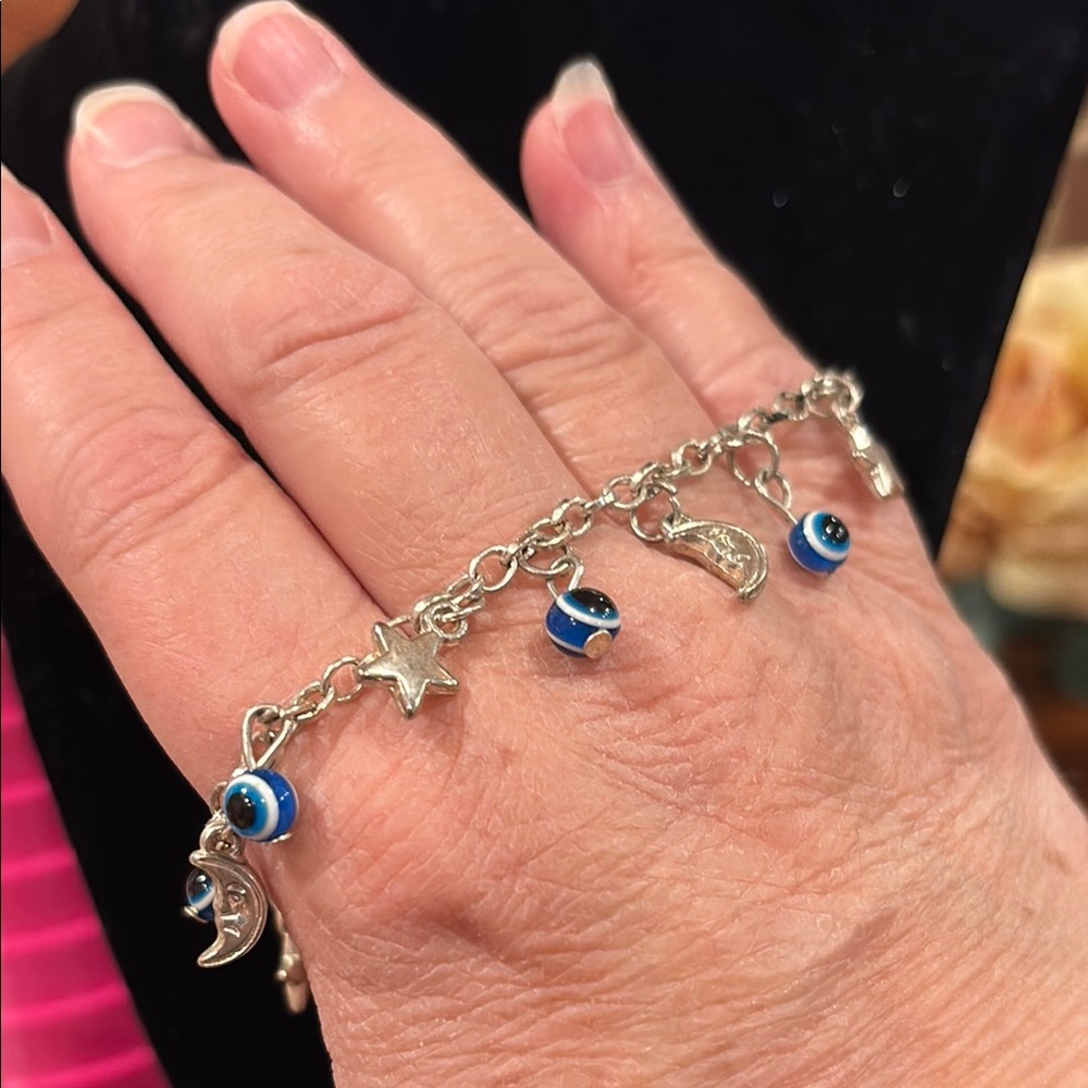 Silver toned  Charm Bracelet with moons, stars and evil eye charms. Adjustable